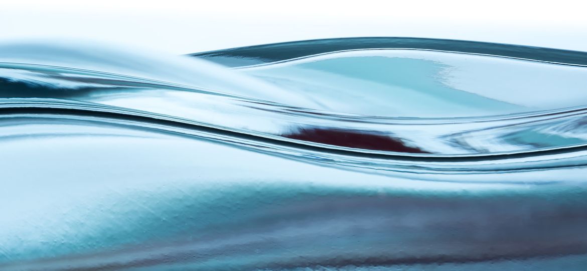 The surface of clear blue water in motion.