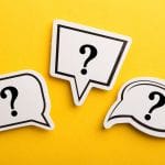 Three speech-bubble shapes with question marks on a bright yellow background